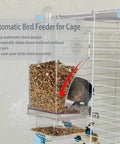 Two Pack Automatic No Mess Bird Cage Feeder Set With Clear Acrylic Food Tray And Blue Water Dispenser For Parrots shows food dispensing.