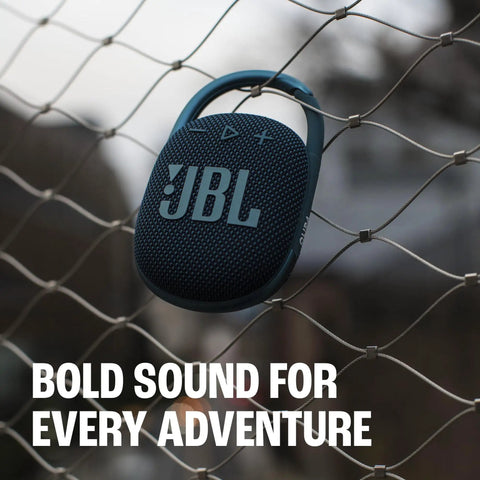 Clip 4 Portable Mini Bluetooth Speaker with Carabiner IP67 Waterproof and Dustproof Design hung on a wire fence outdoors