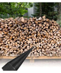 Wood drilling bit with tapered tip and 38 mm round handle in front of stacked firewood.
