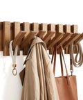 Premium Acacia Wood Wall Mounted Coat Rack With Eight Retractable Hooks displaying coats and bags for space-saving entryway storage.