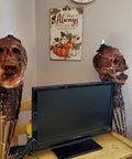 Interior view showing Skull Tiki Torch Set For Halloween Yard Decor, Handcrafted Skull Pattern Outdoor Lights beside a TV.