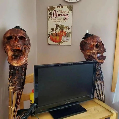 Interior view showing Skull Tiki Torch Set For Halloween Yard Decor, Handcrafted Skull Pattern Outdoor Lights beside a TV.