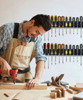 Man in workshop using tools with 2 Pack Wall Mount Screwdriver And Pliers Organizer Rack Heavy Duty Steel Tool Holder in background.