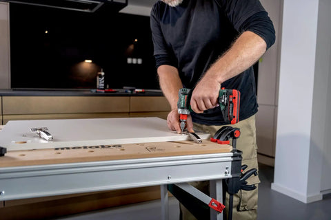 Badass 18 Volt Cordless Brushless Drill Driver delivering 60 Newton Meters of torque used to install hinges on a workbench.