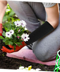 Person wearing Heavy Duty Cut Resistant Arm Sleeves Built Tough For Serious Yard And Mechanic Jobs Deliver Rock Solid Forearm Protection That Truly Holds Up Through Long Days In Matte Black while planting flowers.