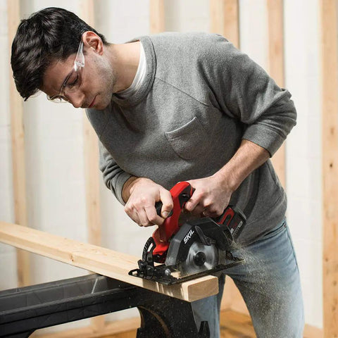 Man using Ultra Compact 12v Brushless Circular Saw Equipped With A Rugged 5 Half Inch Thin Kerf Carbide Blade for precise wood cuts.