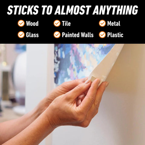 Person using Natural Tan Mounting Putty For Posters And Photos, 84 Pre-Cut Squares Per Pack, Pack Of 3, Non-Toxic, Removable