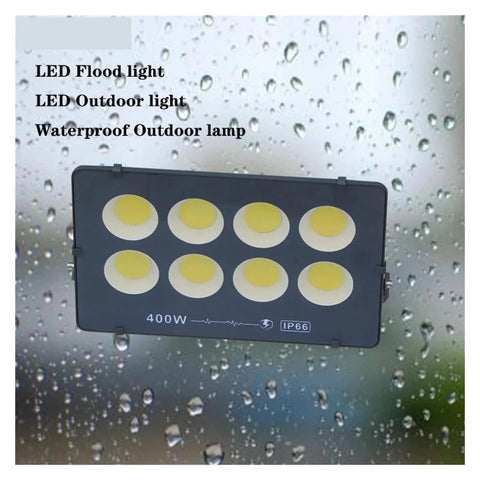 JUDYSSY Ultrathin Led Flood Light 400W shown against rain, highlighting its waterproof design for outdoor use.