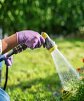 Person using a hose with premium aluminum three quarter inch garden hose quick connectors set on flowers outdoors