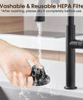 Washing a reusable HEPA filter under a kitchen faucet, demonstrating part of the Powerful Cordless Handheld Vacuum Cleaner