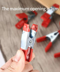 Close-up of a Heavy Duty 2 Inch Metal Spring Clamp with rubber tips showing maximum opening, part of 20-piece set