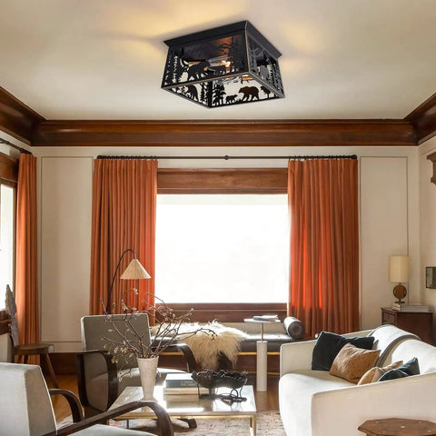 Bear Rustic 2 Light Farmhouse Flush Mount Ceiling Light With Metal Cutout Sides In Anti Rust Black Finish in a cozy living room