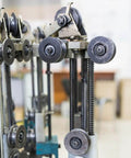 Industrial machine with metal gears and pulleys in a manufacturing setting
