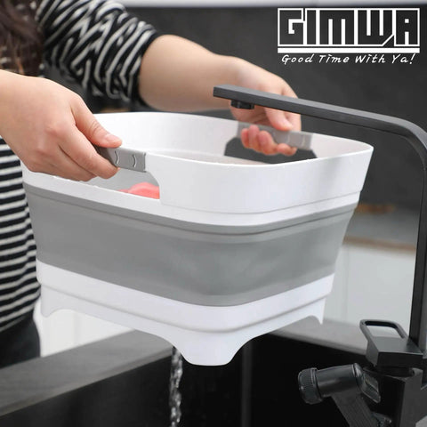 Person using 2.6 Gallon Collapsible Wash Basin With Drain Plug For Baby Bottles And Dishes over sink