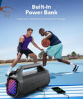 Boom 2 Plus Portable Speaker With 140W BassUp 2.0 beside basketball players charging a phone on a court, power bank feature.