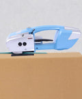 Heavy Duty Electric Rechargeable PET PP Strapping Tool 3 In 1 Bander on cardboard box for quick packaging.