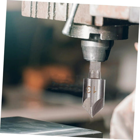 Close-up of a countersink drill bit mounted in a machine from the 5 Piece Countersink Drill Bit Set For Woodworking And Metal Fabrication With Pro Grade Precision Chamfering Tools Versatile Deburring Kit For Carpentry Projects And Metalworking Tasks.