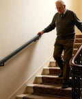 Older man using Heavy Duty Stainless Steel Flush Wall Mounted Handrail Matte Black Stair Railing for safe support on stairs.