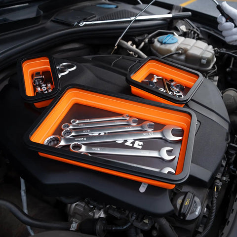 Collapsible Magnetic Parts Organizer Trays with wrenches on car engine