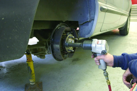 Using the Wheel Stud Installer Tool For Cars And Light Trucks Quick Lug Nut Style Stud Puller with an impact wrench on a car hub