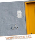 Top Tier Phenofice White Plastic Electrical Junction Box Waterproof Case installed on a wall near a yellow door.
