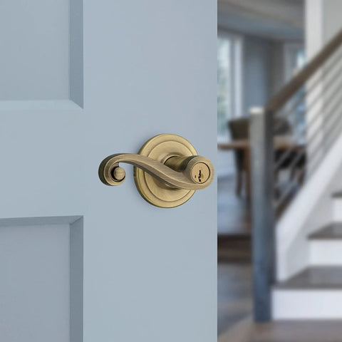 Lido Entry Door Lever With SmartKey Re-Key Security, Antique Brass Finish on door, reversible handle visible