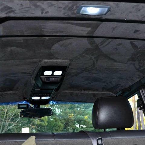 Installed MOTUKA black suede headliner fabric with foam backing in a car interior.