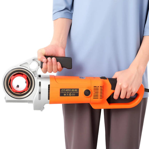 Heavy Hitter Pipe Threader Featuring A 2300W Copper Motor And Easy Roll Ratchet Handle For Lightning Fast Plumbing Runs Includes Six Tough Dies Spanning Half To Two Inches Plus Rugged Job Bag held by a person.