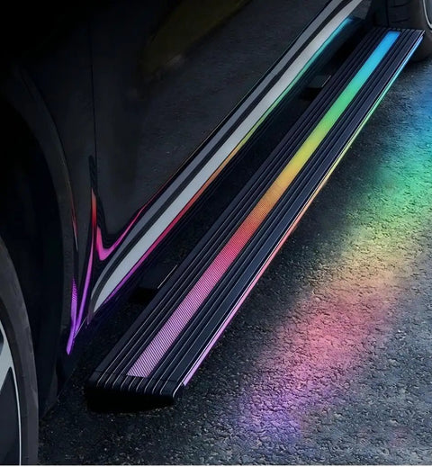 Slick Electric Deployable Running Boards For Tesla Cybertruck with colorful LED lighting on heavy duty cast aluminum side steps.