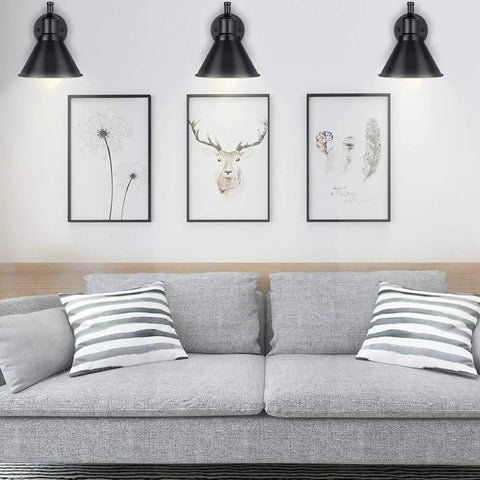 Living room with grey sofa beneath 2 In 1 Plug In Or Hardwired Swing Arm Wall Light Sconce In Industrial Black Finish.