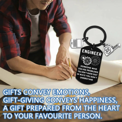 Engraved Engineer Keychain Gift For Men And Students on drafting table, durable stainless steel, cool graduation present.