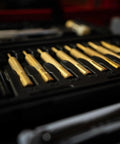 Top Shelf Hammer And Punch Set With Durable Brass Strikers, Polished Steel Heads For Zero Fuss Gunsmithing And Firearm Maintenance, Includes Heavy Duty Storage Box For Your Home Shop Setup featuring brass punches arranged in a storage case.