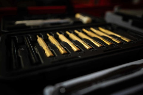Top Shelf Hammer And Punch Set With Durable Brass Strikers, Polished Steel Heads For Zero Fuss Gunsmithing And Firearm Maintenance, Includes Heavy Duty Storage Box For Your Home Shop Setup featuring brass punches arranged in a storage case.