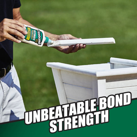 Person applying Ultimate Wood Glue For Strong Bonds in 16 Ounce Bottle to outdoor wooden planter, highlighting unbeatable bond strength.