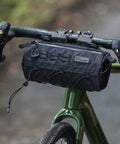 2.8L Waterproof Front Tube Bag For Road Gravel And Mountain Bikes on handlebars, showing cylindrical design and tear-resistant nylon