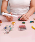 Person using All In One Resin Polishing Kit With Electric Rotary Drill And UV Light on resin pieces with accessories in view