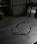 Flexible Drive Shaft 4137 711 3202 Replacement For FS90R FS91R FS110R FS80R Trimmers on a workshop table.