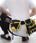 Heavy Duty 360 Swivel Utility Belt With Quick Grab Pockets Ergonomic Waist Tool Pack Jobsite Ready Tough As Nails Canvas Gear Organizer For Electricians And Craftsman Hustlers seen from behind with tools in pockets.