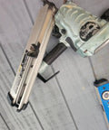 Steel Pneumatic Rafter Hook Hanger With One Quarter Inch Air Tool Swivel Fitting on a framing nailer against a wooden surface