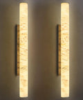 Natural Alabaster Wall Sconces Set Of Two Cylinder LED Wall Lights With Matte Black Metal Base Modern smooth glow illuminating walls.