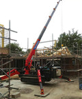 Mini Portable Crawler Crane Rig With Smart Wireless Remote Hydraulic Lift Machine Fully Kitted Out With Quick Swap Telescopic Boom and Fly Jib on construction site.
