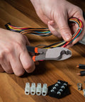 Dang Tough Lightweight Wire Strippers And Cutting Pliers Featuring Slick Ergonomic Rubber Grips and Rock Solid Steel Build for Seasoned Trade Electricians and Contractors cutting colorful electrical wires.