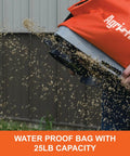 25 Lb Handheld Bag Seeder Spreader With Waterproof Bag And Enclosed Gears Adjustable Gate Opening Rear Baffle Deflector And Adjustable Shoulder Strap Built For Small Yards In Bright Orange showing seeds dispersing