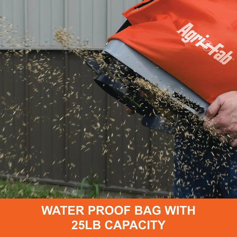 25 Lb Handheld Bag Seeder Spreader With Waterproof Bag And Enclosed Gears Adjustable Gate Opening Rear Baffle Deflector And Adjustable Shoulder Strap Built For Small Yards In Bright Orange showing seeds dispersing
