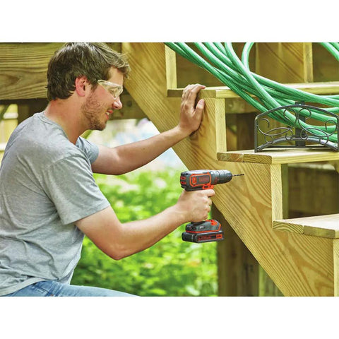 Man using 20V Max Cordless Drill Driver Kit With Battery And Charger Includes Double Ended Bit Lightweight 3.15 Lbs 11 Position Clutch For Precision 0 To 650 RPM Delivers 115 Lbs Of Torque For Wood Metal Plastic Projects Your Go To Power Tool on outdoor wooden stairs.