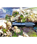 1300 Lumen Narrow Beam Dive Light with Tail Switch nestled among rocks, demonstrating snorkel and dive use, 10 degree beam focus.