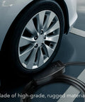 Level 2 Electric Vehicle Charger 40 Amp 240 Volt NEMA 14 50 Plug 16 Ft Cable next to a car wheel in a parking spot.
