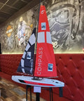 53 Inch Wind Powered Remote Control RC Sailing Boat with 2.4G Radio displayed indoors, showcasing ABS fiberglass hull and vibrant sails