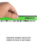 Hand holding 36 Piece Magnetic Hex Bit Holder Kit For Fast Drill Bit Storage And Organization Mounts To Metal Surfaces, green color.