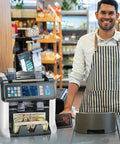 Man in apron with Multi Currency Money Counter With Counterfeit Detection And Sorter, Printer Enabled, in a store setting